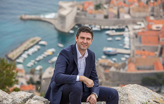 mayor of Dubrovnik posing outside the city.