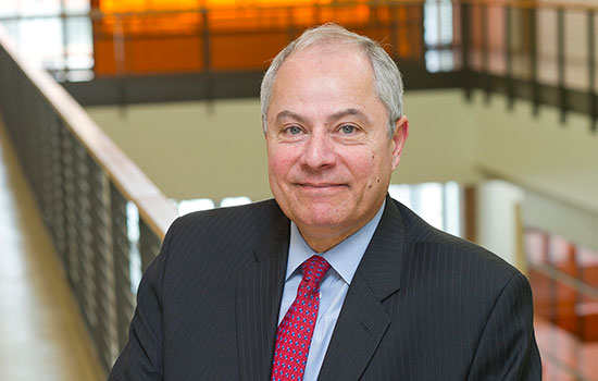 Professor posing for camera in stairwell