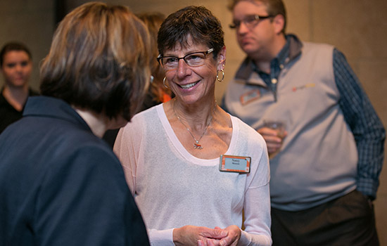 Nancy Munson talking to people at event