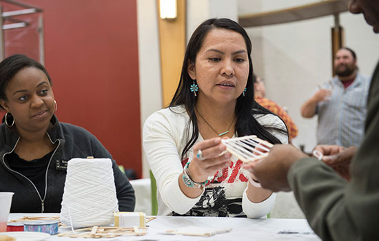 Person holding item for packaging science hands-on activity.