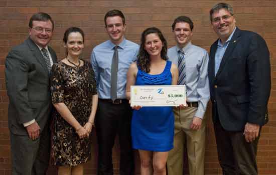 People posing with check at event