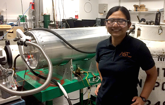 Student, Chi Nguyen, standing next to infrared machine