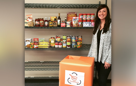 Person posing by shelfs with food