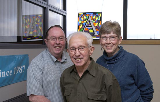 Three Professors standing side by side in an office