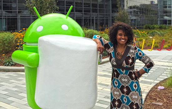 Keita Wangari next to android statue.