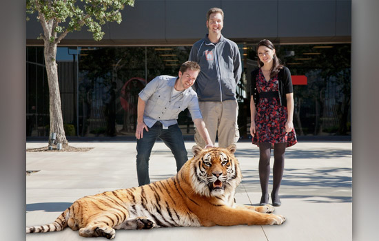 People posing with CGI tiger