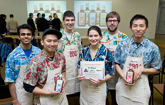 People posing with award at event