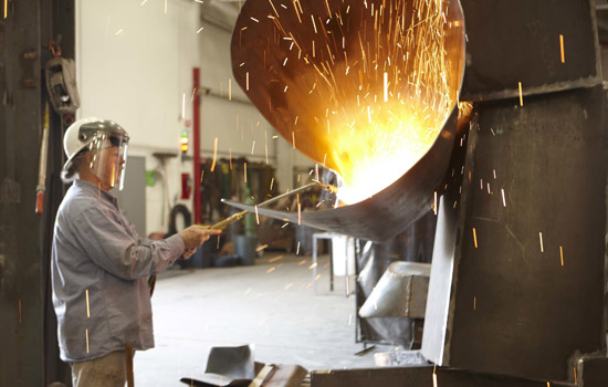 Person welding large piece of metal