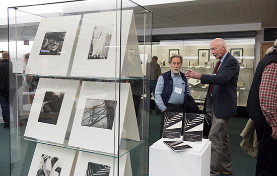 Two people looking at photography exhibit.