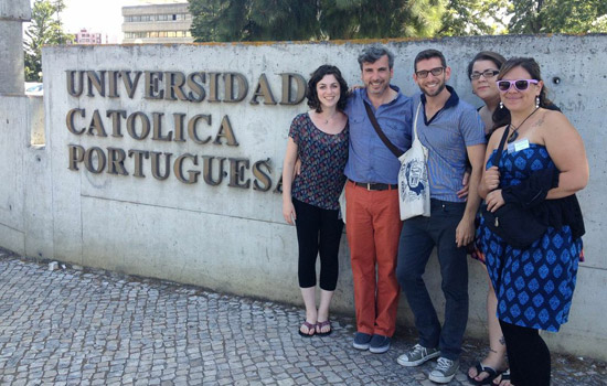 People posing next to "Universidad Catolica Portuguesa"