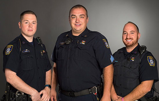 Three officers in uniform.