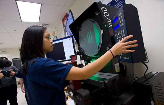 Jasmine Phan presses buttons on the OVI meteorology equipment, preparing to demonstrate how it works.