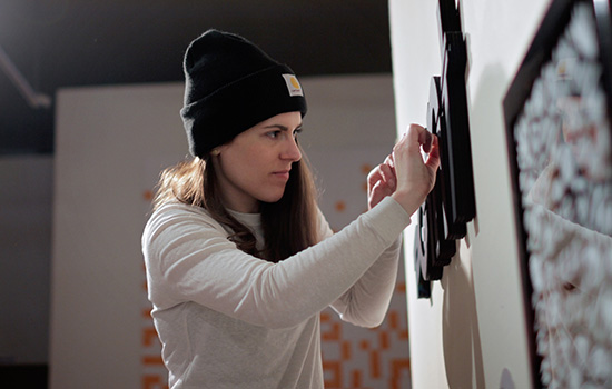 Person handing word on wall