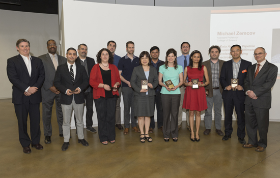 group of researchers holding awards and posing for a photo.