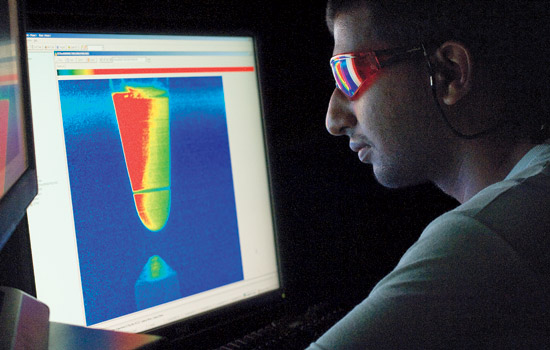 student looking at cone-shaped image of data.