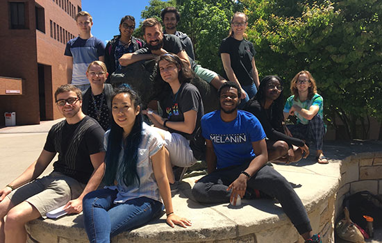 Group of students gather for a picture on campus.