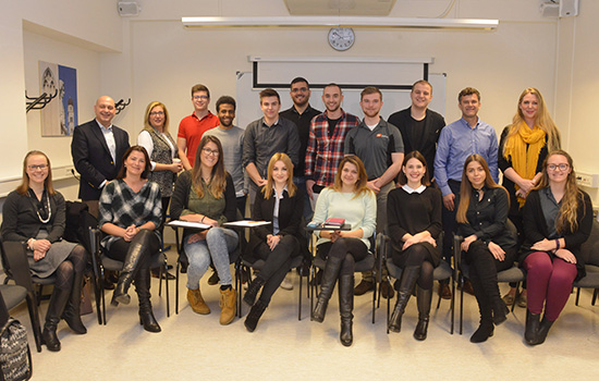 People gathered for picture in classroom