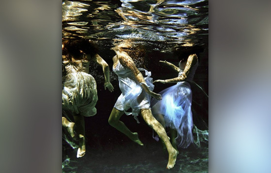 Picture of people in dresses underwater