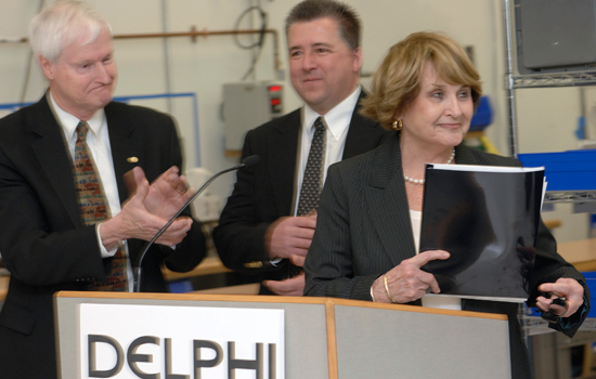 RIT President, Congresswomen, and Chief Engineer at podium labeled "DELPHI"