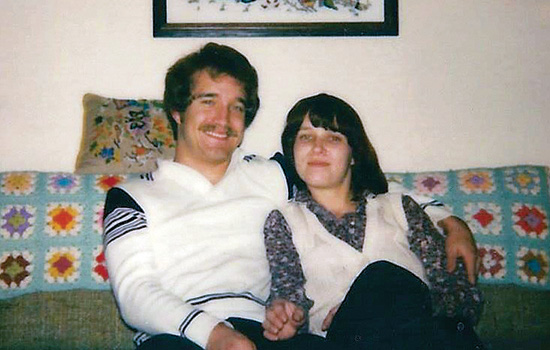 Two people posing on couch