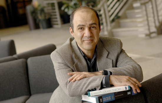 Person posing for camera with textbooks