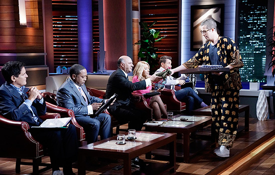 Person speaking with Shark tank hosts