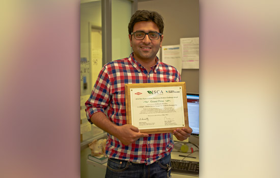 Person posing with award