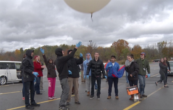 People releasing balloon into the air