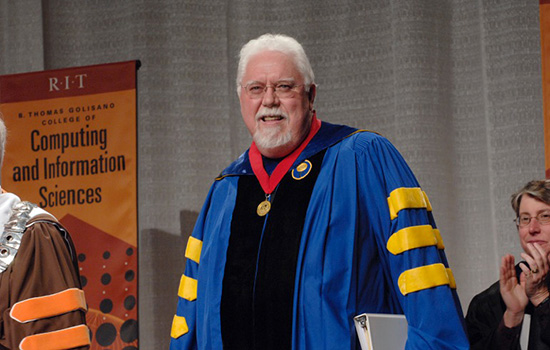 Professor speaking on stage for graduation