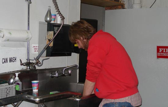 Student washing their hands in a sink