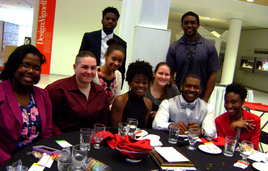 People posing around table 