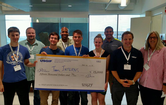 People posing with giant check