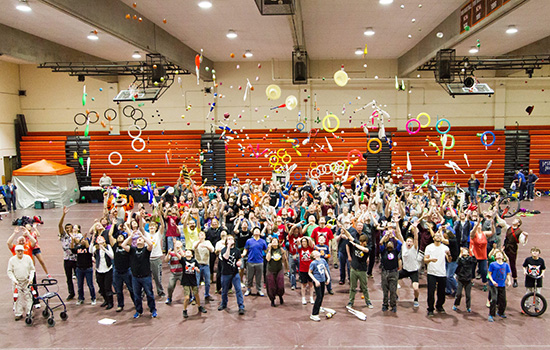 People throwing juggling equipment in the air