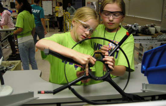 Kids looking at car parts