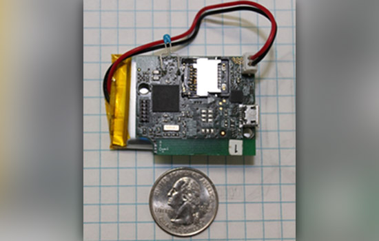 Picture of device next to coin