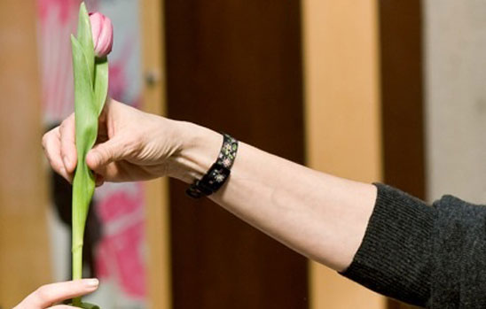 Picture of person giving flower to person