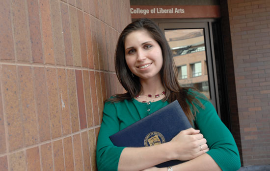 Student standing near building entrance