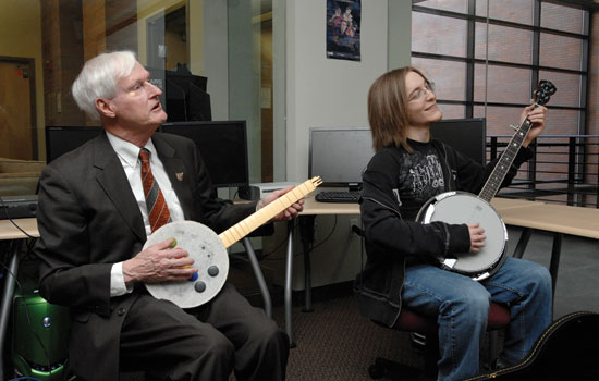 RIT president and student playing instruments