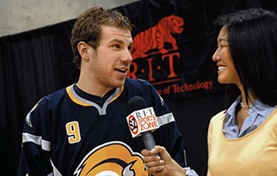 Hockey player answering questions for reporter