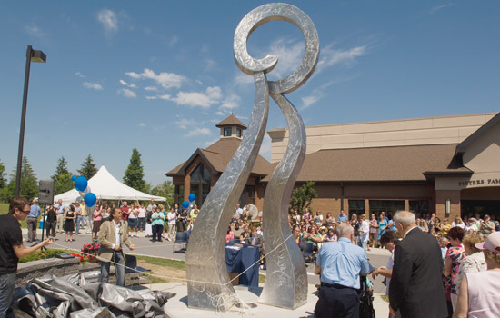 People gathered around sculpture