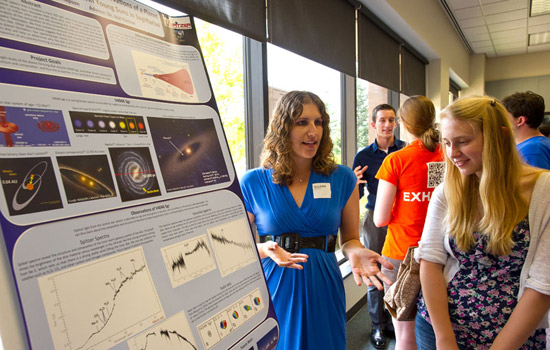 People discussing poster at event