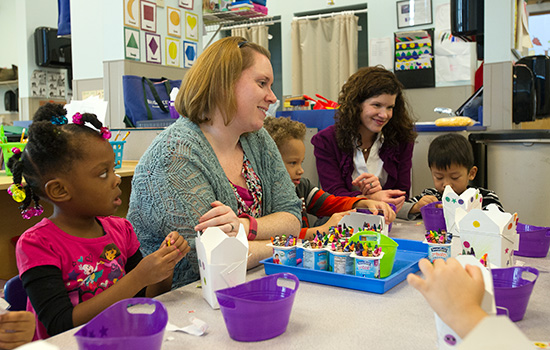 People teaching children in classroom