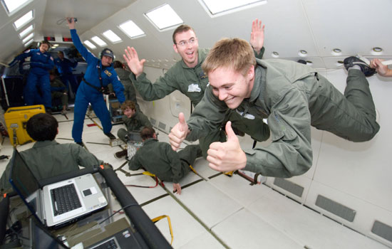 Students floating in zero gravity environment
