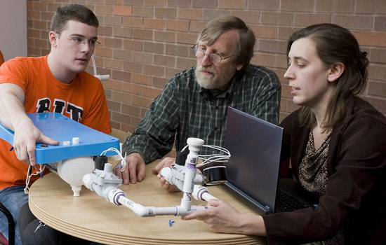 People gathered around table looking at project