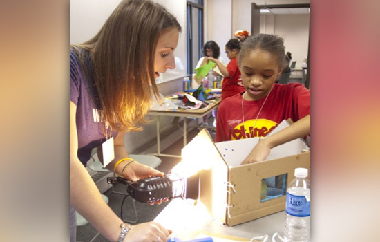 Picture of student and kids working on project