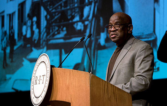 William Davis Jr. standing behind an RIT podium