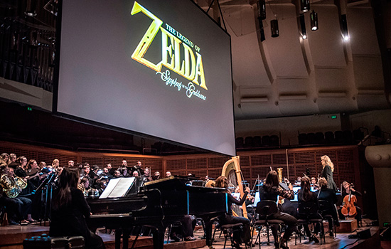 Musicians performing on stage with Legend of Zelda logo