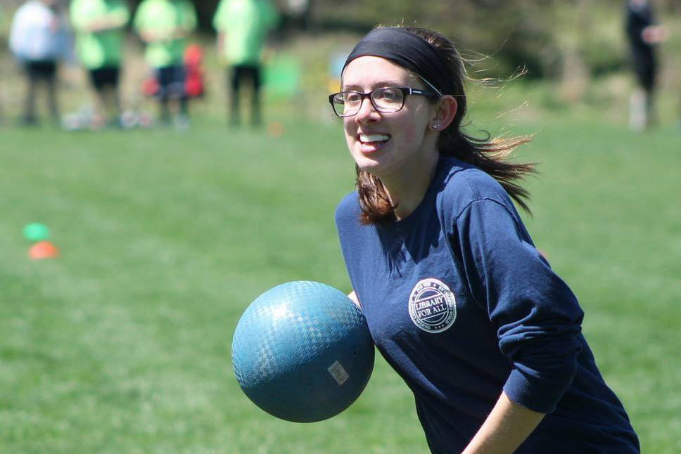 Laurel Perweiler running and carrying a ball while playing quidditch.