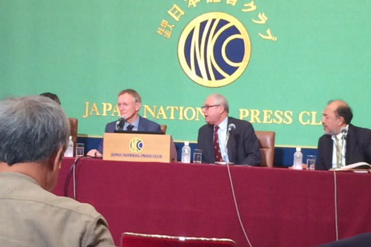 Four men sitting at a table and speaking on a panel at the Japanese National Press Club.