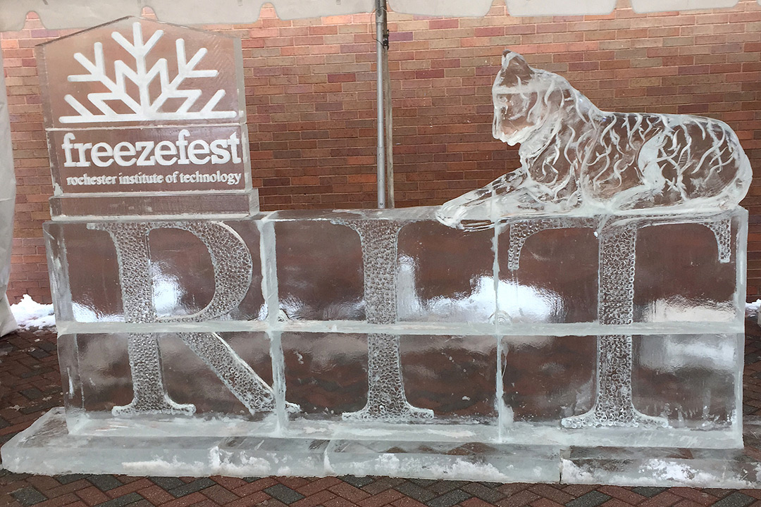 Ice sculpture of the word RIT with a tiger sitting on top